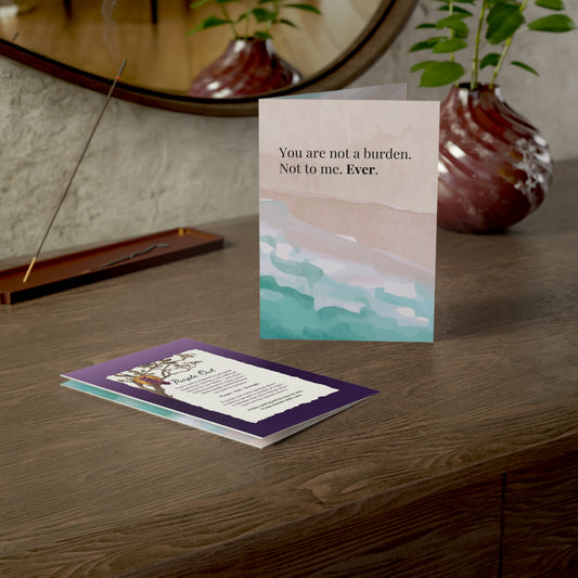Greeting card with motivational message on a wooden surface with decorative items.